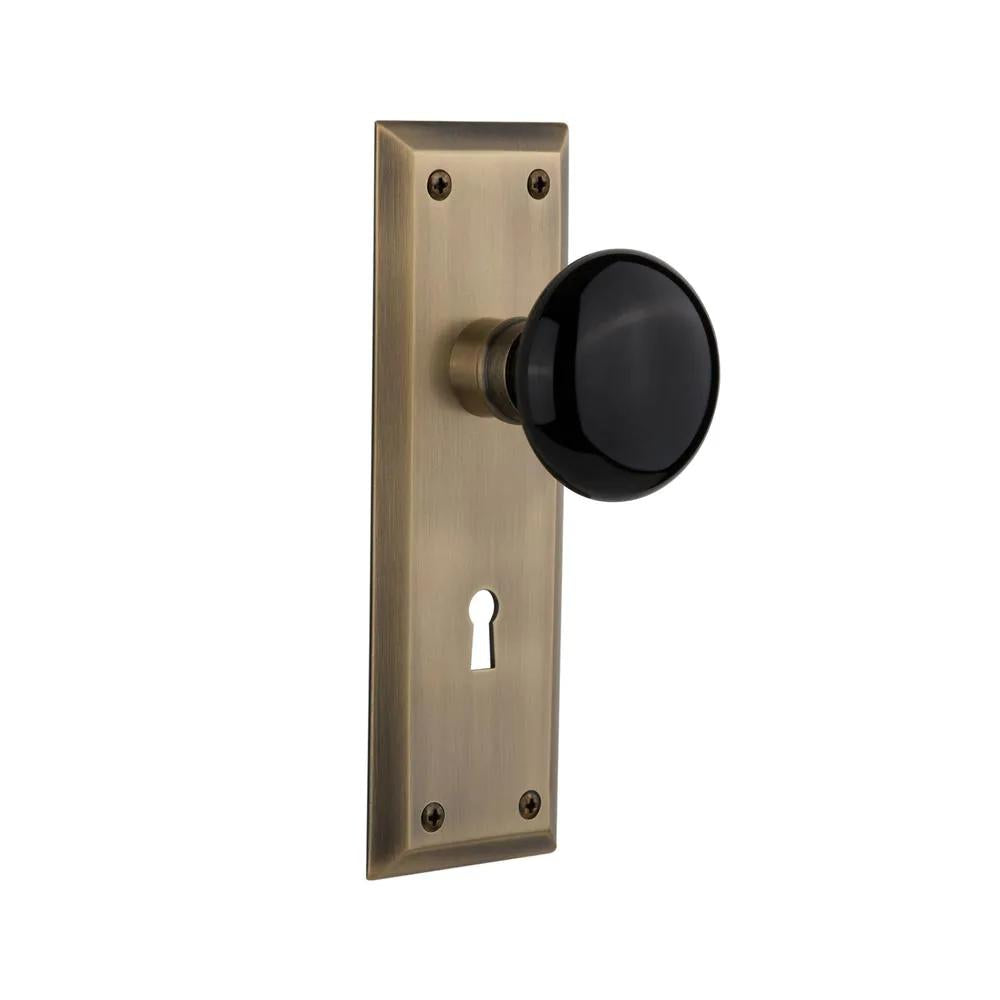 York Plate Interior Mortise Black Porcelain Door Knob in Antique Brass