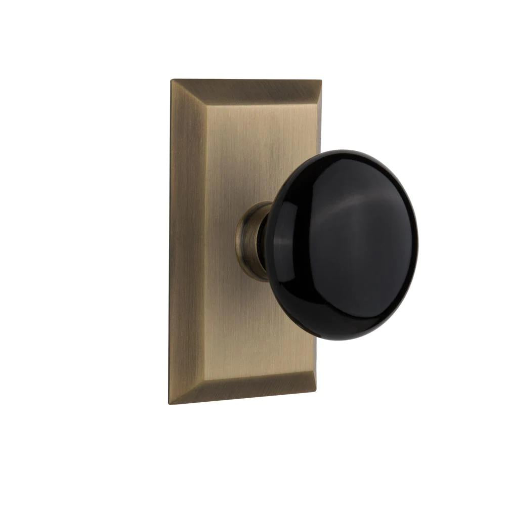 Studio Plate 2-3/8 in. Backset Antique Brass PassaHall/Closet Black Porcelain Door Knob